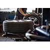 Wheel balancing or repair and change car tire at auto service garage or workshop by mechanic