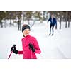 Cross-country skiing: young woman cross-country skiing on a winter day