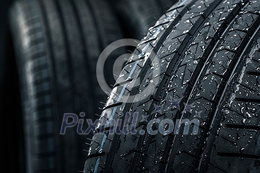 Stack of brand new high performance car tires on clean high-key white studio background Stack of brand new high performance car tires on clean high-key white studio background