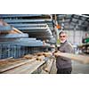 DIY concept -Senior man choosing and buying construction wood in a DIY store for his DIY home re-modeling project