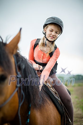Cute young girl riding a horse Cute young girl riding a horse