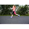 Young woman running outdoors on a lovely sunny winter/fall day (motion blurred image)