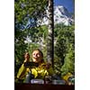 Female hiker/climber preparing supper on gas burner in a camp