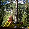 Female hiker/climber preparing supper on gas burner in a camp