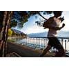 Fit man runnig by a lake (motion blurred image; color toned)