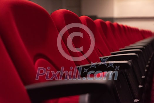 empty conference,theater or cinema hall with rows of red seats empty conference,theater or cinema hall with rows of red seats