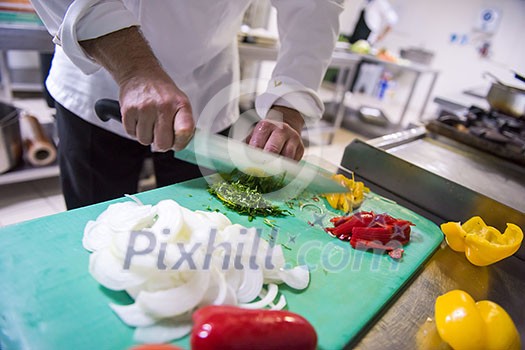 Chef hands cutting fresh and delicious vegetables for cooking or salad Chef hands cutting fresh and delicious vegetables for cooking or salad