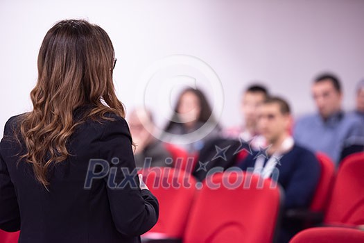 young businesswoman at business conference room with public giving presentations. Audience at the conference hall. Entrepreneurship club young businesswoman at business conference room with public giving presentations. Audience at the conference hall. Entrepreneurship club