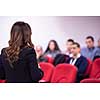 young businesswoman at business conference room with public giving presentations. Audience at the conference hall. Entrepreneurship club