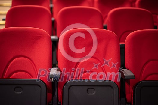 empty conference,theater or cinema hall with rows of red seats empty conference,theater or cinema hall with rows of red seats