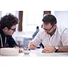 Group of a young business people brainstorming and discussing business plan on meeting at startup office interior