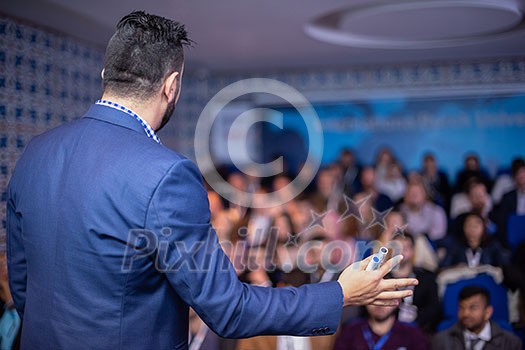 young businessman at business conference room with public giving presentations. Audience at the conference hall. Entrepreneurship club young businessman at business conference room with public giving presentations. Audience at the conference hall. Entrepreneurship club