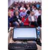 laptop computer and microphone at podium on business seminar education  in modern conference room