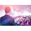 young businessman at business conference room with public giving presentations. Audience at the conference hall. Entrepreneurship club