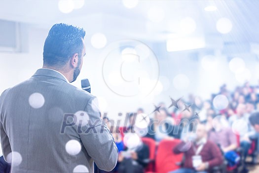 young businessman at business conference room with public giving presentations. Audience at the conference hall. Entrepreneurship club young businessman at business conference room with public giving presentations. Audience at the conference hall. Entrepreneurship club