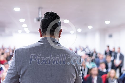 young businessman at business conference room with public giving presentations. Audience at the conference hall. Entrepreneurship club young businessman at business conference room with public giving presentations. Audience at the conference hall. Entrepreneurship club