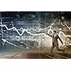 Young businessman running and tryinhg to catch up with something