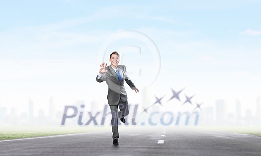Young businessman in suit running on asphalt road Young businessman in suit running on asphalt road