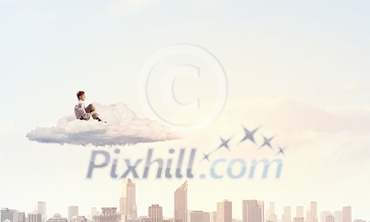 Depressed young businessman sitting alone on cloud high in sky Depressed young businessman sitting alone on cloud high in sky