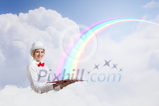 Young woman in white cylinder and red bowtie with book in hands Young woman in white cylinder and red bowtie with book in hands