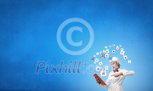 Young emotional woman in white cylinder with book in hand Young emotional woman in white cylinder with book in hand