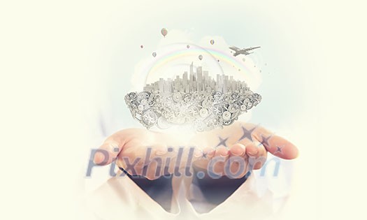 Small urban island with modern city in male hands Small urban island with modern city in male hands
