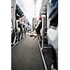 Interior of commercial airplane with passengers in their seats during flight.