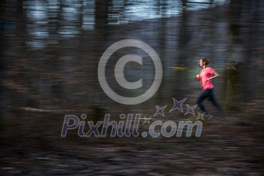Young woman running outdoors in a forest, going fast (motion blurred image) Young woman running outdoors in a forest, going fast (motion blurred image)