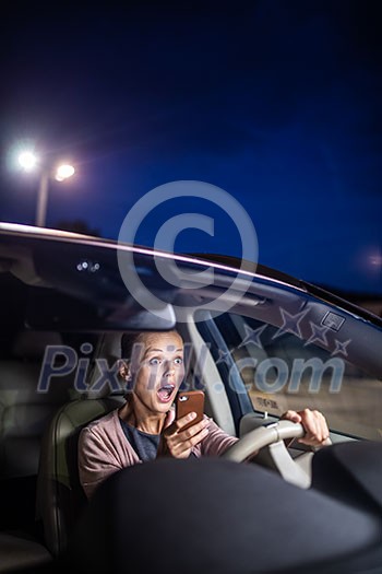 Young female driver playing with her cellphone instead of paying attention to driving startled in a potentially dangerous situation - Road safety concept Young female driver playing with her cellphone instead of paying attention to driving startled in a potentially dangerous situation - Road safety concept