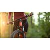 Pretty, young woman biking on a mountain bike enjoying healthy active lifestyle outdoors in summer (shallow DOF)