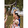 group of young friends playing Beach volleyball in a beautiful nature on the bank of the river