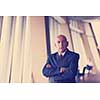 portrait of senior business man alone in modern corporate  office indoors