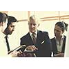 young startup businessman making presentation of project to senior investior, group of business people taking notes and make plans on white  flip board and tablet computer