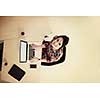 top view of young business woman working on laptop computer in modern bright startup office interior