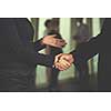 partnership concept with senior  business man and woman make hand shake and take agreement in modern office interior