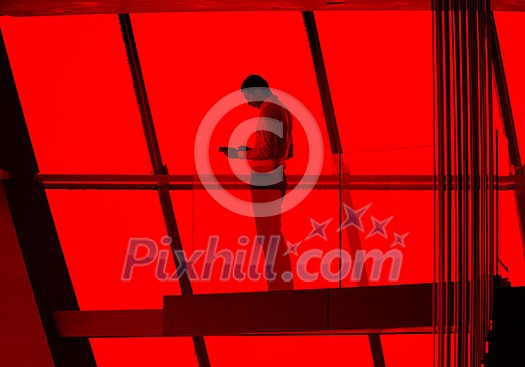 young successful business man in penthouse working on tbalet,  modern bright duplex office apartment interior  with staircase and big windows