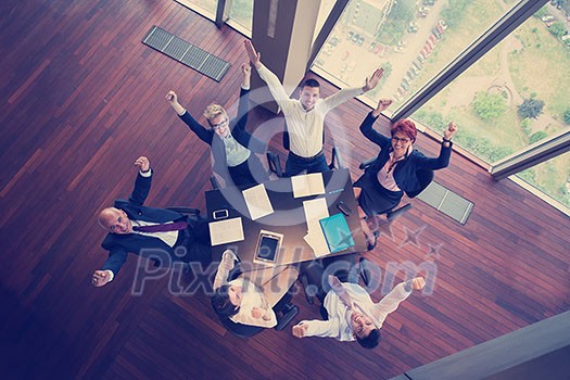 top view of happy business people group on meeting throwing documents in air at modern office interior top view of happy business people group on meeting throwing documents in air at modern office interior