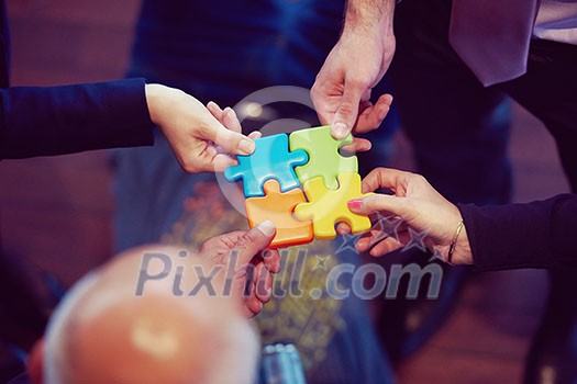 business people group assembling jigsaw puzzle and represent team support and help concept, top view perspective at modern bright office interior business people group assembling jigsaw puzzle and represent team support and help concept, top view perspective at modern bright office interior