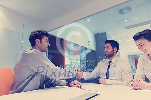 signing contract on partners back, young couple on business meeting with life insurance and bank loan agent at modern office interior signing contract on partners back, young couple on business meeting with life insurance and bank loan agent at modern office interior
