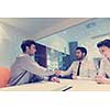 signing contract on partners back, young couple on business meeting with life insurance and bank loan agent at modern office interior