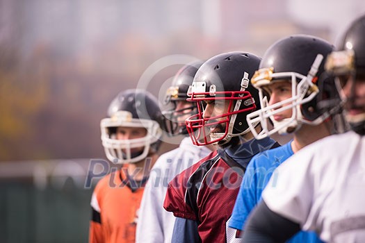 portrait of young american football team standing one behind the other on field portrait of young american football team standing one behind the other on field
