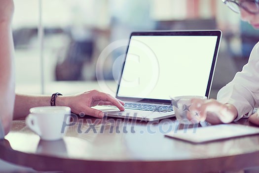 startup business people using laptop preparing for next meeting while drinking coffee and discussing ideas in creative office startup business people using laptop preparing for next meeting while drinking coffee and discussing ideas in creative office