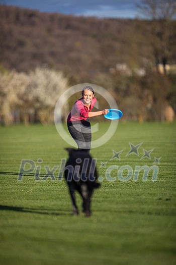 Portrait of a black dog running fast outdoors, playing with frisbee (shallow DOF, sharp focus Portrait of a black dog running fast outdoors, playing with frisbee (shallow DOF, sharp focus