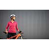 Pretty, young woman biking on a mountain bike enjoying healthy active lifestyle outdoors in summer (shallow DOF)