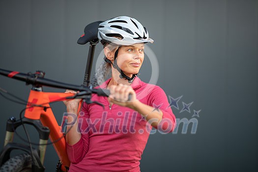 Pretty, young woman biking on a mountain bike enjoying healthy active lifestyle outdoors in summer (shallow DOF) Pretty, young woman biking on a mountain bike enjoying healthy active lifestyle outdoors in summer (shallow DOF)