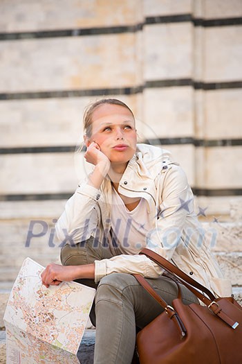 Gorgeous female tourist with a map discovering a foreign city (shallow DOF; color toned image) Gorgeous female tourist with a map discovering a foreign city (shallow DOF; color toned image)