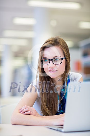 Pretty, female college student in a library, looking for a book (shallow DOF; color toned image) Pretty, female college student in a library, looking for a book (shallow DOF; color toned image)