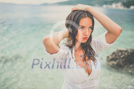 Woman relaxing at the beach with arms open enjoying her freedom,  independence, good health, time off.