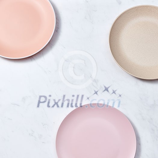 Top view of porcelain plates handmade. Ceramic glazed plates are empty on a gray background with copy space. Top view of porcelain plates handmade. Ceramic glazed plates are empty on a gray background with copy space.