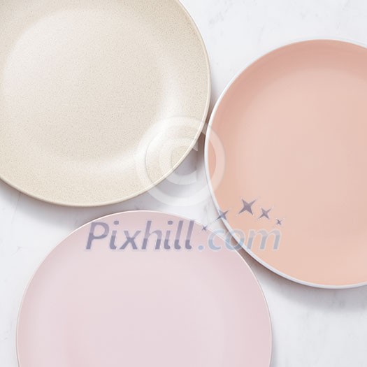 Traditional decorative ceramic handcraft plates covered with glazed on a gray background with place for text. Flat lay Traditional decorative ceramic handcraft plates covered with glazed on a gray background with place for text. Flat lay